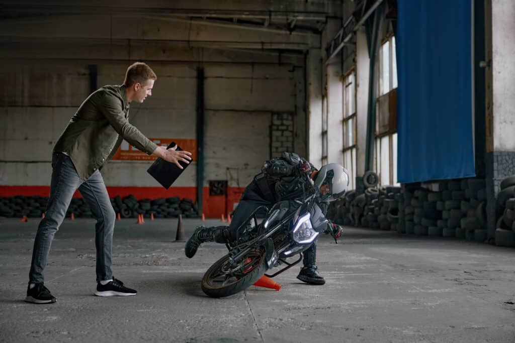Student falling from motorcycle at training class in driving school
