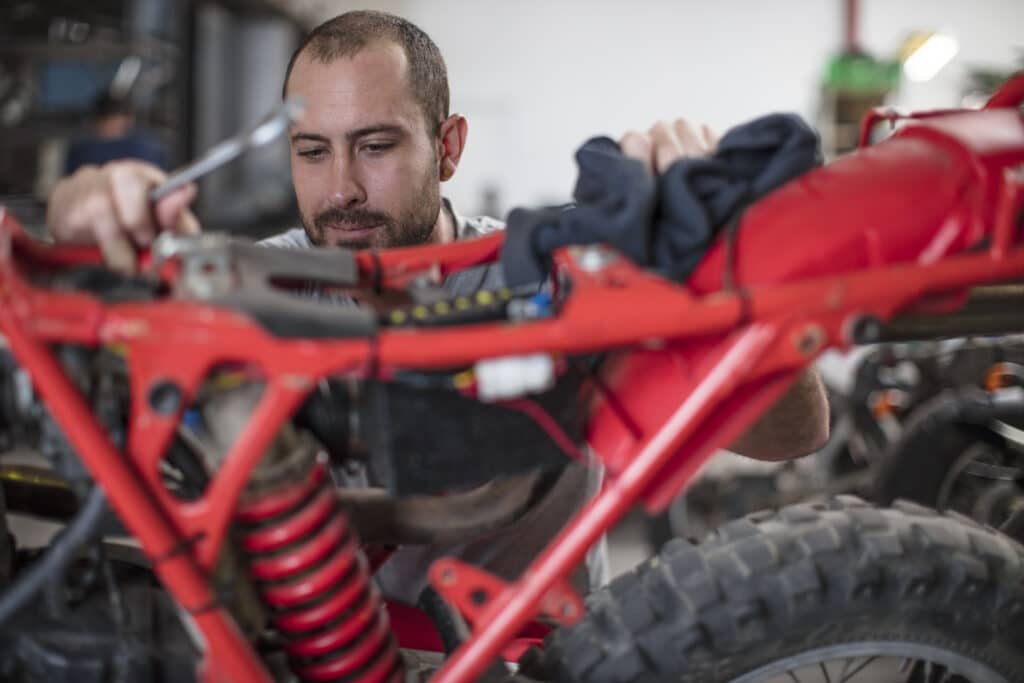 Mechanic working on motorcycle in workshop