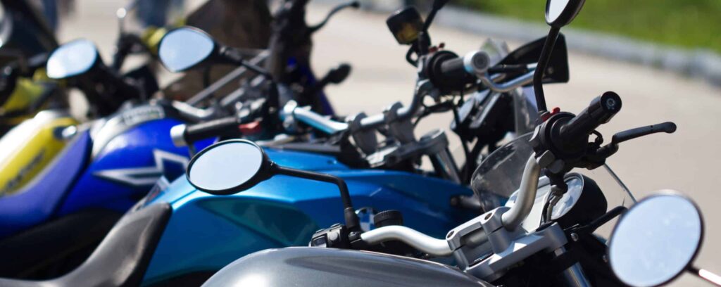 vertical detail row of parked motorcycles in the street selective focus