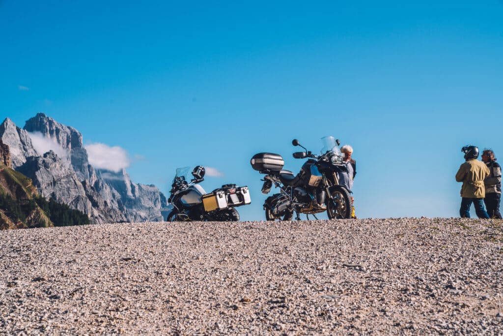 Parked motorcycle in a beautiful mountainous area with scenery view. Motorcycle summer trip in Europe