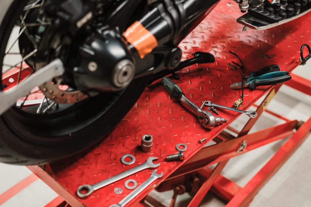 Fixing Custom motorcycle standing in repair shop. Instruments and equipment. Hobbies and unique Jobs