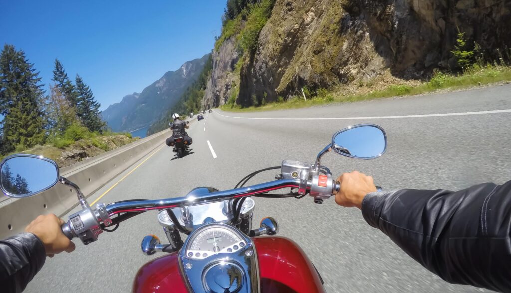 Riding on a motorcycle during a sunny summer day. Taken on Sea to Sky Highway near Squamish, North of Vancouver, BC, Canada