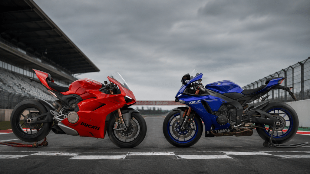 photorealistic side by side comparison Ducati Panigale V4 red and Yamaha YZF-R1 blue on empty racetrack, wide angle, overcast light, no watermark