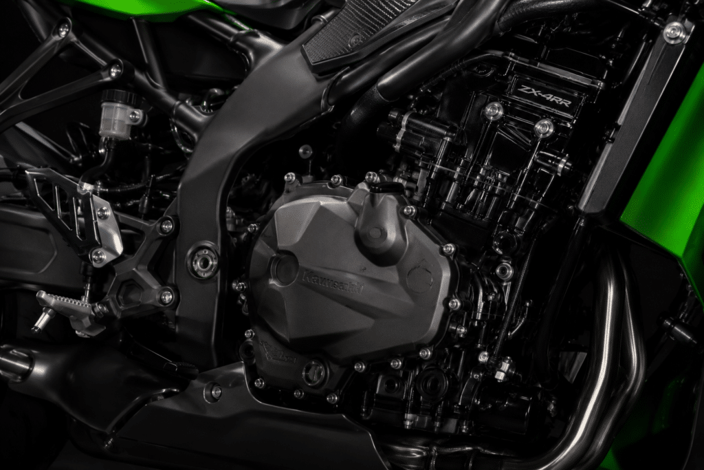 photorealistic close-up Kawasaki ZX-4RR inline four cylinder engine, studio lighting, matte green and black finish, engineering detail, no watermark