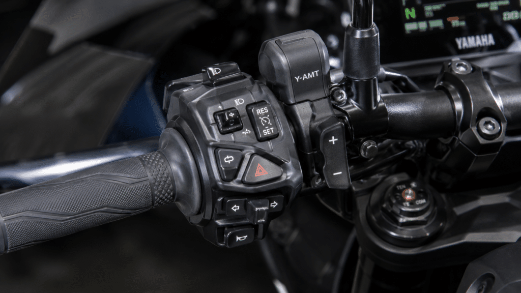 photorealistic close-up of Yamaha MT-07 handlebar controls showing Y-AMT paddle shifters and left-hand control without clutch lever, modern technical motorcycle detail photography, dramatic sidelight, sharp focus on control interface, no watermark